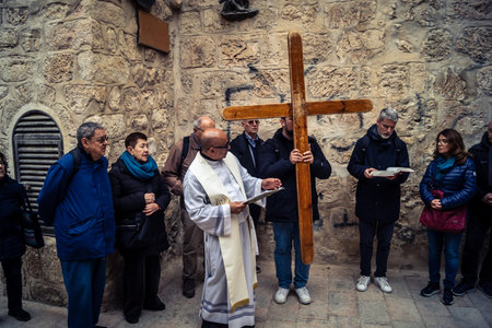 â€‹Jerusalem, Israel - February 21, 2026: Christian pilgrims carry large wooden crosses and...