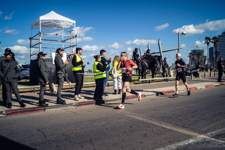 Tel Aviv, Israel, February 27, 2026 Marathon participants run past security forces standing guard...