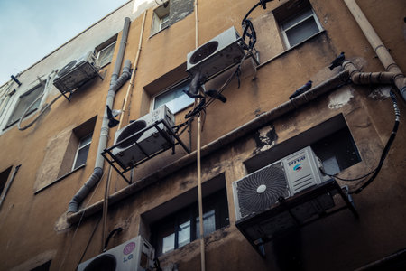 Tel Aviv, Israel - February 23, 2026: Numerous air conditioning units are installed on the exterior...