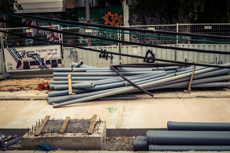Tel Aviv, Israel, March 14, 2026 Construction equipment for the new tramway stands motionless during Shabbat as the desert sand reclaims the urban landscape, creating a scene of eerie stillness and suspended progress.のeditorial素材