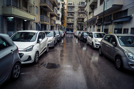 Tel Aviv, Israel, March 21, 2026 Street view of Tel Aviv under the rain with light reflections on the wet pavement and moody urban atmosphere.のeditorial素材