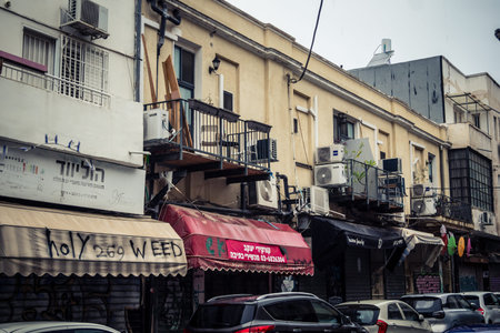 Tel Aviv, Israel, March 21, 2026 Street view of Tel Aviv under the rain with light reflections on...