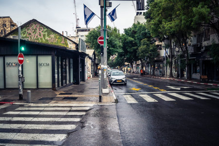 Tel Aviv, Israel, March 21, 2026 Street view of Tel Aviv under the rain with light reflections on...