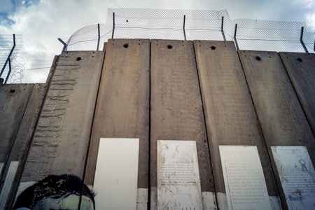 Bethlehem, West Bank, Palestine, March 23, 2026 Sharp coils of razor wire and heavy duty security...