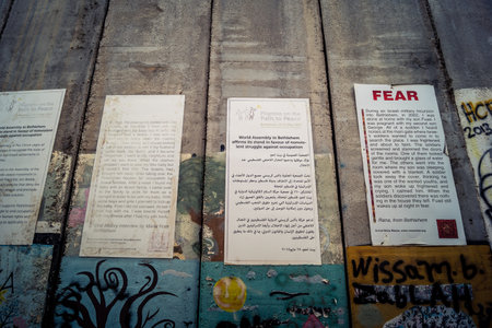 Bethlehem, West Bank, Palestine, March 23, 2026 Colorful and provocative political graffiti, murals, and messages of resistance cover the massive concrete slabs of the Israeli separation wall. These artistic expressions serve as a powerful form of non vioのeditorial素材