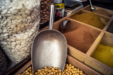 Hebron, West Bank, Palestine, March 25, 2026 Inside a traditional and bustling Palestinian grocery store specialized in bulk spices, dried fruits, and nuts in the heart of the historic old city of Hebron. The market stall is a sensory oasis, displaying doのeditorial素材