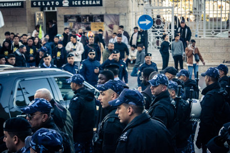 Bethlehem, West Bank, December 24, 2025 Palestinian police officers stand guard outside the main police headquarters in Bethlehem during the Christmas celebrations.のeditorial素材
