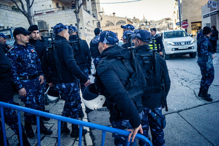 Bethlehem, West Bank, December 24, 2025 Palestinian police officers stand guard outside the main police headquarters in Bethlehem during the Christmas celebrations.のeditorial素材
