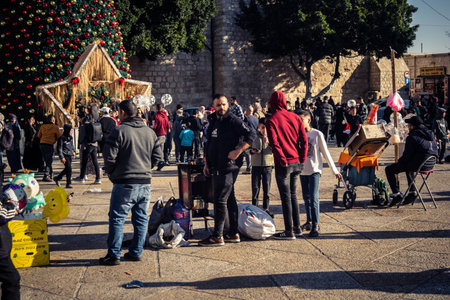 Bethlehem, West Bank, December 25, 2025 Tourists and locals gather in Manger Square, in front of the Church of the Nativity, to celebrate Christmas and enjoy the festive atmosphere in the holy city.のeditorial素材