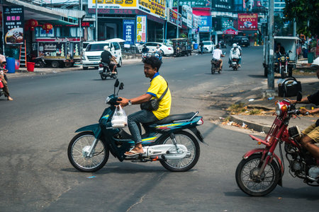 Sihanoukville, Cambodia, February 3, 2025 Traffic in the streets of Sihanoukville, a coastal city in Cambodia. Renowned for its rich cultural heritage, bustling market and vibrant street life.のeditorial素材