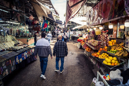 Tel Aviv, Israel - February 25, 2026 Daily life and morning bustle at the Carmel Market (Shuk HaCarmel), largest open-air marketplace. Local vendors and authentic street scenes in the heart of Tel Aviv.のeditorial素材