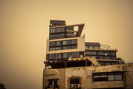 Tel Aviv, Israel, March 14, 2026 A thick layer of desert sand and dust blankets the streets during a Sharav atmospheric phenomenon, creating a surreal orange glow and reducing visibility across the metropolitan area.のeditorial素材
