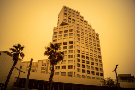 Tel Aviv, Israel, March 14, 2026 A thick layer of desert sand and dust blankets the streets during a Sharav atmospheric phenomenon, creating a surreal orange glow and reducing visibility across the metropolitan area.のeditorial素材