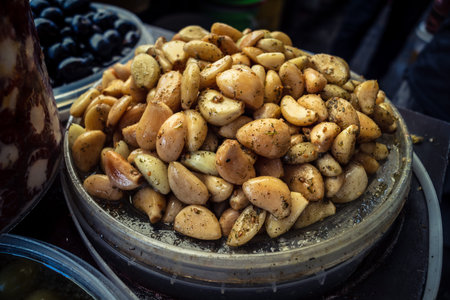 Hebron, West Bank, Palestine, March 28, 2026 A traditional Palestinian market stall in the historic old city of Hebron displays a sensory abundance of marinated olives and pickled vegetables. Dozens of open bowls and sacks overflow with aromatic products のeditorial素材