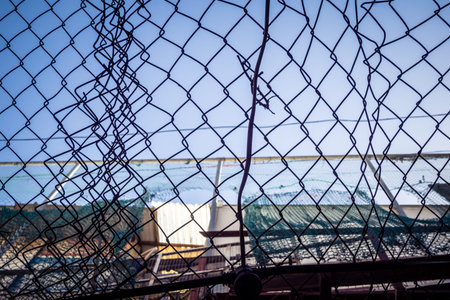 Hebron, West Bank, Palestine, March 28, 2026 Metal nets and fencing are stretched high above the...