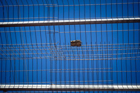 Hebron, West Bank, Palestine, March 28, 2026 Metal nets and fencing are stretched high above the narrow Palestinian commercial streets in the historic old city of Hebron. These installations serve as essential protection for local residents and shoppers aのeditorial素材