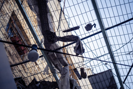 Hebron, West Bank, Palestine, March 28, 2026 Metal nets and fencing are stretched high above the narrow Palestinian commercial streets in the historic old city of Hebron. These installations serve as essential protection for local residents and shoppers aのeditorial素材