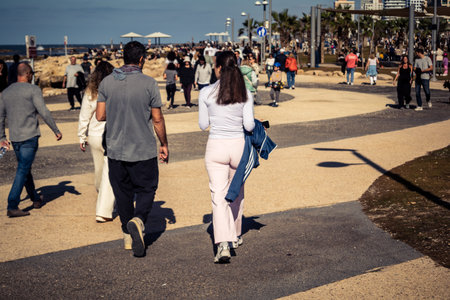 Tel Aviv, Israel, January 3, 2026 Passersby stroll along the Tel Aviv promenade facing the Mediterranean Sea, demonstrating daily resilience despite regional security tensions in the Middle East.のeditorial素材