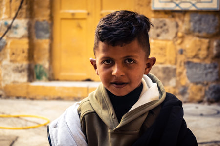 Hebron, West Bank, Palestine, March 28, 2026 Palestinian children are seen smiling at the camera, riding bicycles through narrow alleys and eating ice cream in the historic stone streets of Hebron's old city. These scenes take place in the H2 area, a sectのeditorial素材