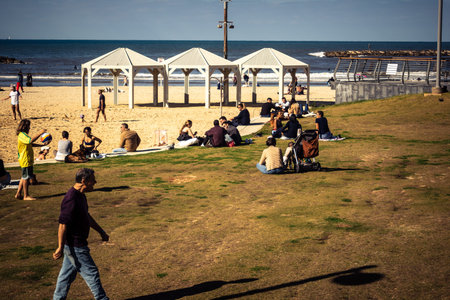 Tel Aviv, Israel, January 3, 2026 Passersby stroll along the Tel Aviv promenade facing the Mediterranean Sea, demonstrating daily resilience despite regional security tensions in the Middle East.のeditorial素材