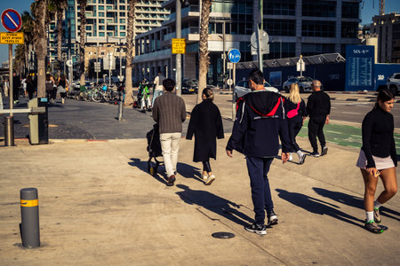 Tel Aviv, Israel, January 3, 2026 Passersby stroll along the Tel Aviv promenade facing the Mediterranean Sea, demonstrating daily resilience despite regional security tensions in the Middle East.のeditorial素材