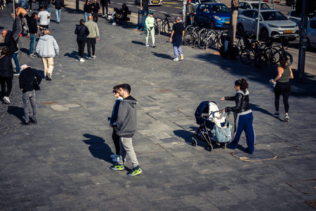 Tel Aviv, Israel, January 3, 2026 Passersby stroll along the Tel Aviv promenade facing the Mediterranean Sea, demonstrating daily resilience despite regional security tensions in the Middle East.のeditorial素材