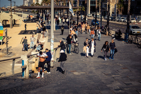 Tel Aviv, Israel, January 3, 2026 Passersby stroll along the Tel Aviv promenade facing the Mediterranean Sea, demonstrating daily resilience despite regional security tensions in the Middle East.のeditorial素材