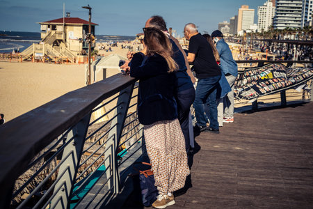 Tel Aviv, Israel, January 3, 2026 Passersby stroll along the Tel Aviv promenade facing the Mediterranean Sea, demonstrating daily resilience despite regional security tensions in the Middle East.のeditorial素材