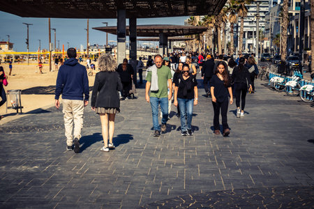 Tel Aviv, Israel, January 3, 2026 Passersby stroll along the Tel Aviv promenade facing the...