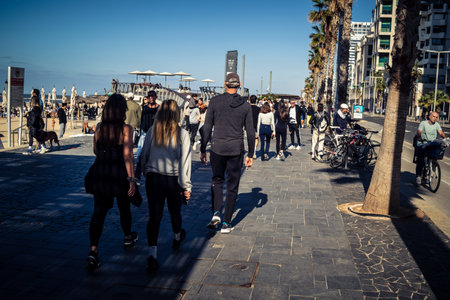 Tel Aviv, Israel, January 3, 2026 Passersby stroll along the Tel Aviv promenade facing the Mediterranean Sea, demonstrating daily resilience despite regional security tensions in the Middle East.のeditorial素材