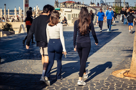 Tel Aviv, Israel, January 3, 2026 Passersby stroll along the Tel Aviv promenade facing the...