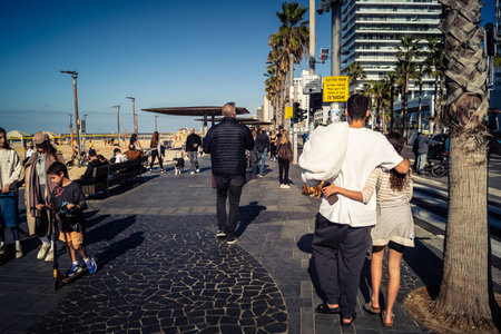 Tel Aviv, Israel, January 3, 2026 Passersby stroll along the Tel Aviv promenade facing the Mediterranean Sea, demonstrating daily resilience despite regional security tensions in the Middle East.のeditorial素材
