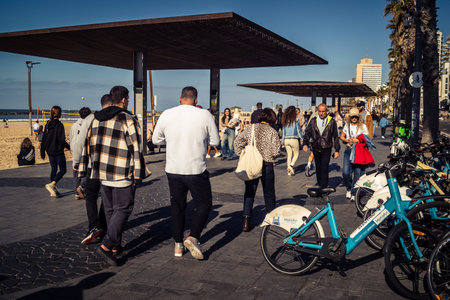 Tel Aviv, Israel, January 3, 2026 Passersby stroll along the Tel Aviv promenade facing the Mediterranean Sea, demonstrating daily resilience despite regional security tensions in the Middle East.のeditorial素材