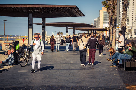 Tel Aviv, Israel, January 3, 2026 Passersby stroll along the Tel Aviv promenade facing the...