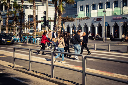 Tel Aviv, Israel, January 3, 2026 Passersby stroll along the Tel Aviv promenade facing the...