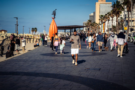 Tel Aviv, Israel, January 3, 2026 Passersby stroll along the Tel Aviv promenade facing the Mediterranean Sea, demonstrating daily resilience despite regional security tensions in the Middle East.のeditorial素材