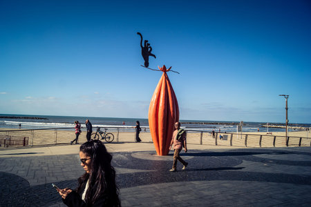Tel Aviv, Israel, January 3, 2026 Passersby stroll along the Tel Aviv promenade facing the Mediterranean Sea, demonstrating daily resilience despite regional security tensions in the Middle East.のeditorial素材