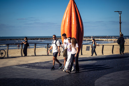 Tel Aviv, Israel, January 3, 2026 Passersby stroll along the Tel Aviv promenade facing the Mediterranean Sea, demonstrating daily resilience despite regional security tensions in the Middle East.のeditorial素材