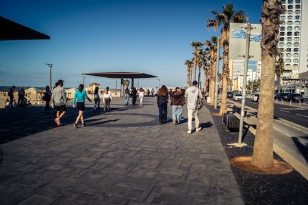 Tel Aviv, Israel, January 3, 2026 Passersby stroll along the Tel Aviv promenade facing the Mediterranean Sea, demonstrating daily resilience despite regional security tensions in the Middle East.のeditorial素材