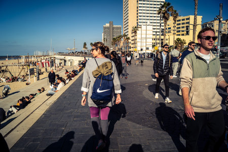 Tel Aviv, Israel, January 3, 2026 Passersby stroll along the Tel Aviv promenade facing the Mediterranean Sea, demonstrating daily resilience despite regional security tensions in the Middle East.のeditorial素材