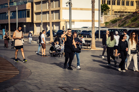 Tel Aviv, Israel, January 3, 2026 Passersby stroll along the Tel Aviv promenade facing the Mediterranean Sea, demonstrating daily resilience despite regional security tensions in the Middle East.のeditorial素材