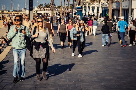 Tel Aviv, Israel, January 3, 2026 Passersby stroll along the Tel Aviv promenade facing the Mediterranean Sea, demonstrating daily resilience despite regional security tensions in the Middle East.のeditorial素材