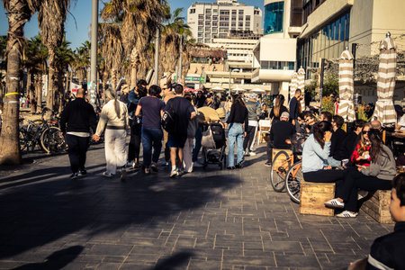 Tel Aviv, Israel, January 3, 2026 Passersby stroll along the Tel Aviv promenade facing the Mediterranean Sea, demonstrating daily resilience despite regional security tensions in the Middle East.のeditorial素材