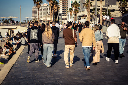 Tel Aviv, Israel, January 3, 2026 Passersby stroll along the Tel Aviv promenade facing the Mediterranean Sea, demonstrating daily resilience despite regional security tensions in the Middle East.のeditorial素材