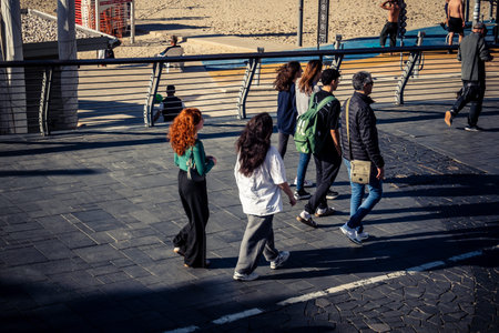 Tel Aviv, Israel, January 3, 2026 Passersby stroll along the Tel Aviv promenade facing the Mediterranean Sea, demonstrating daily resilience despite regional security tensions in the Middle East.のeditorial素材
