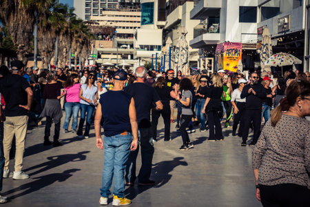 Tel Aviv, Israel, January 3, 2026 Passersby stroll along the Tel Aviv promenade facing the Mediterranean Sea, demonstrating daily resilience despite regional security tensions in the Middle East.のeditorial素材
