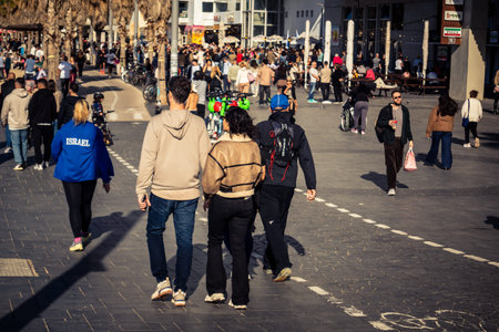 Tel Aviv, Israel, January 3, 2026 Passersby stroll along the Tel Aviv promenade facing the Mediterranean Sea, demonstrating daily resilience despite regional security tensions in the Middle East.のeditorial素材