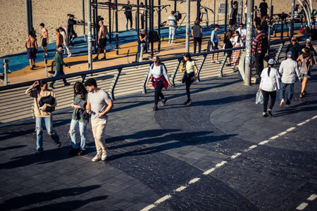 Tel Aviv, Israel, January 3, 2026 Passersby stroll along the Tel Aviv promenade facing the Mediterranean Sea, demonstrating daily resilience despite regional security tensions in the Middle East.のeditorial素材