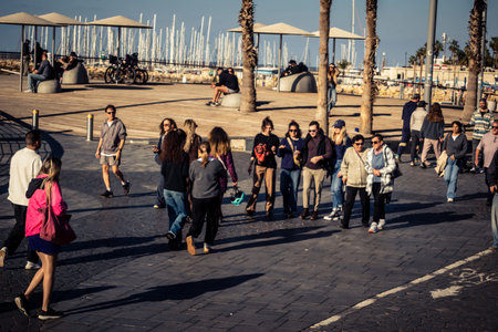 Tel Aviv, Israel, January 3, 2026 Passersby stroll along the Tel Aviv promenade facing the Mediterranean Sea, demonstrating daily resilience despite regional security tensions in the Middle East.のeditorial素材