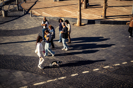 Tel Aviv, Israel, January 3, 2026 Passersby stroll along the Tel Aviv promenade facing the Mediterranean Sea, demonstrating daily resilience despite regional security tensions in the Middle East.のeditorial素材